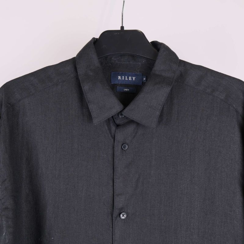 Övre delen av svart skjorta med krage och knappar