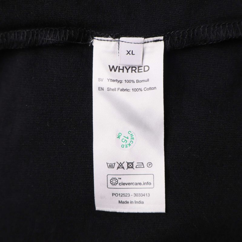 Material- och tvättrådsetikett som visar 100% bomull och storlek XL