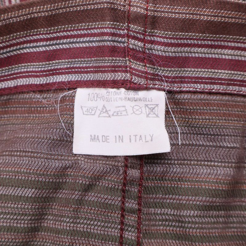 Tvättrådsetikett med information om 100% bomull