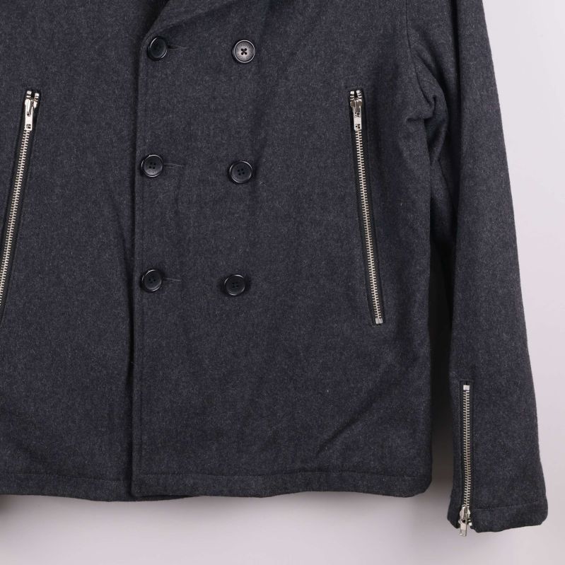 Nedre framstycke av jacka tydliggör fickdjur och sömmar