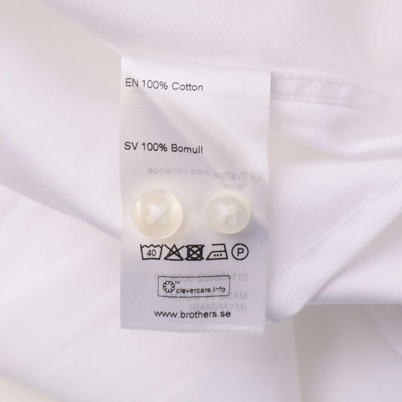 Materiallapp som visar 100% bomull och tvättsymboler