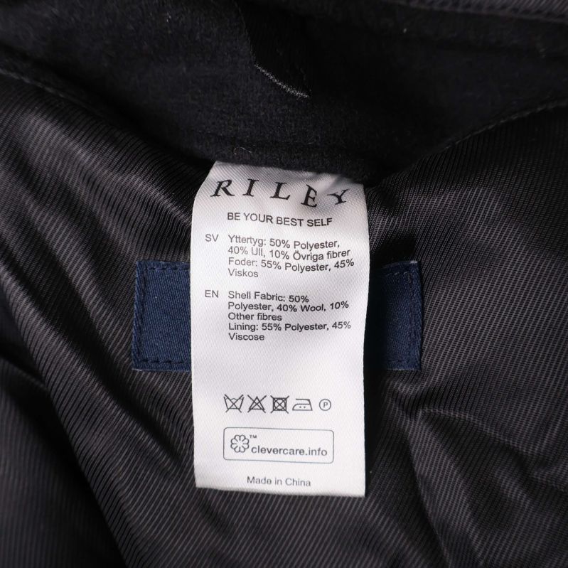 Tvättrådsetikett med materialinfo för Riley kappa