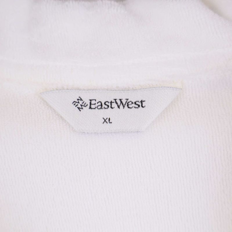 Närbild etikett East West och storlek XL