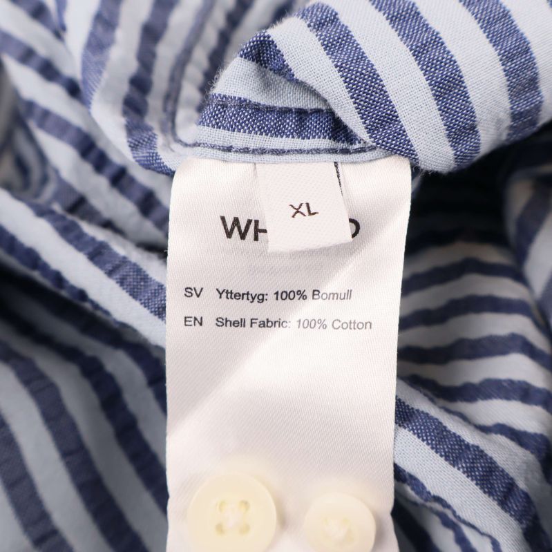 Materiallapp visar 100% bomull och storlek XL