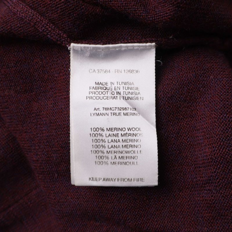 Materiallapp med text 100% merinoull på flera språk