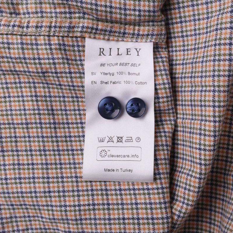 Skötselråd och materialetikett med extraknappar