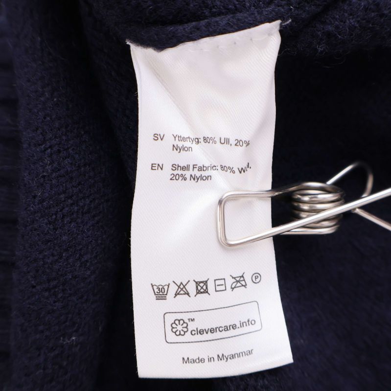 Materiallapp som visar 80% ull och 20% nylon