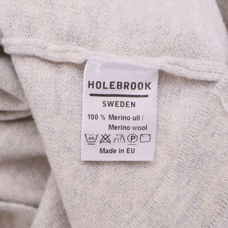 Tvättrådsetikett som visar 100% merinoull från Holebrook