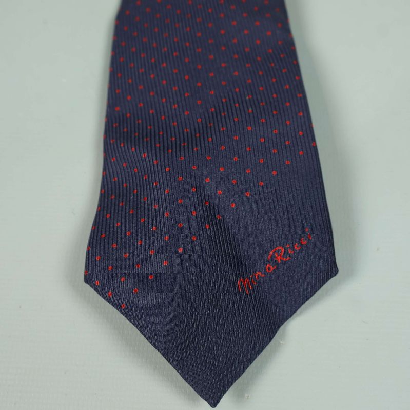 Närbild på spetsen av slipsen med broderad logotyp