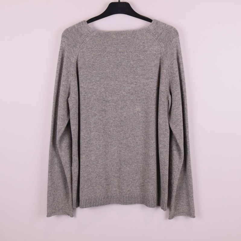Grå stickad tröja bakifrån på galge