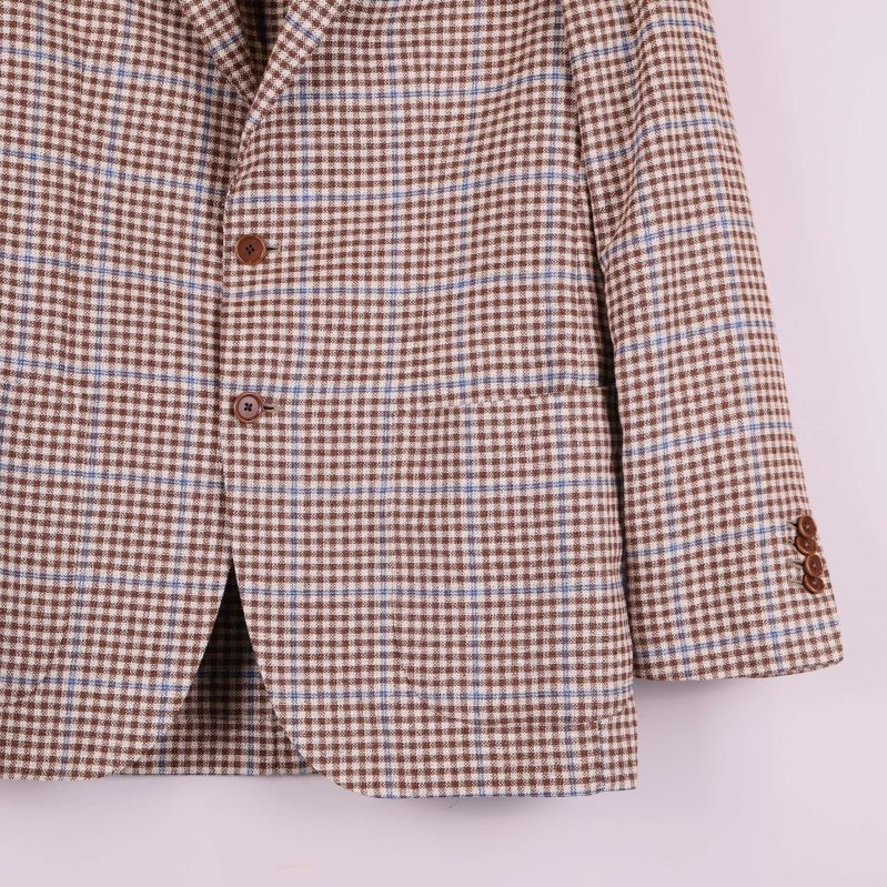 Närbild på ärm och knappar samt fickor framtill