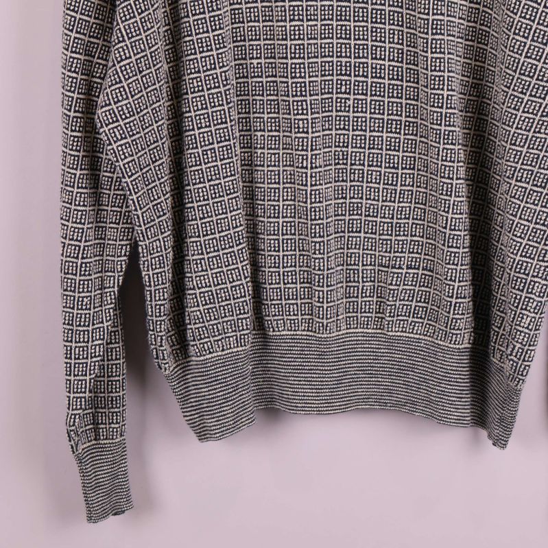 Nedre del av tröja med ribbade muddar och grafiskt mönster