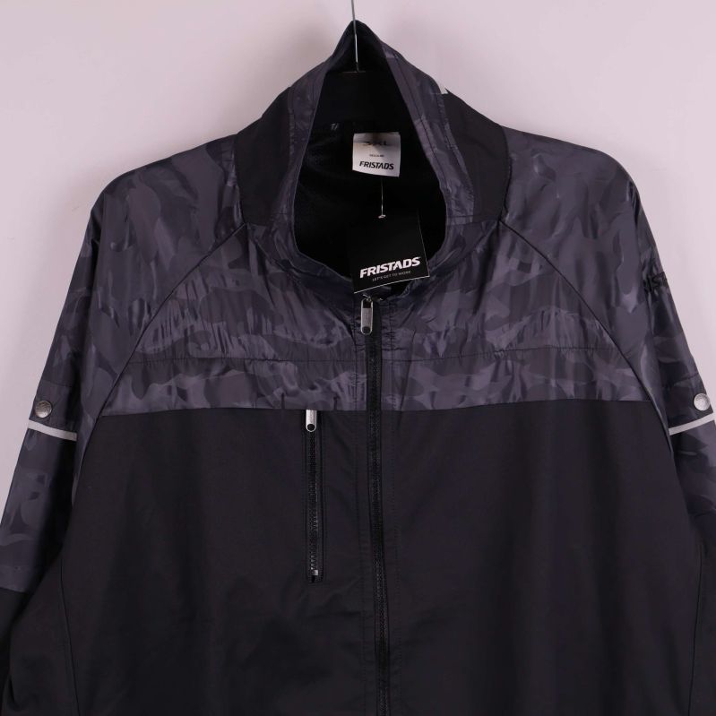 Närbild på jackans bröstparti och mönstrade tyg