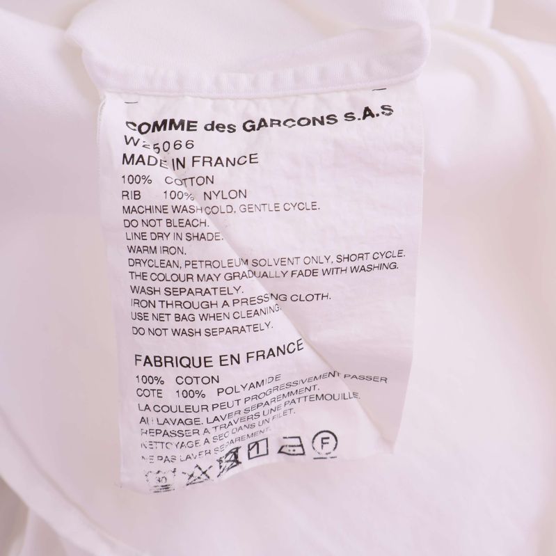 Materialetikett med komposition 100% bomull och 100% nylon