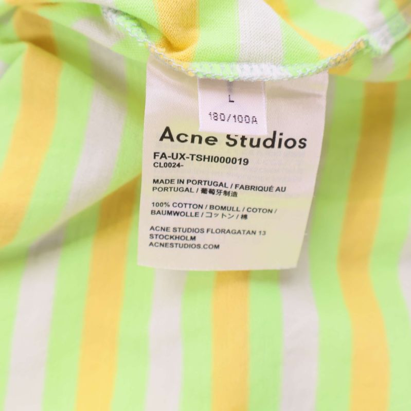 Materialetikett med information om bomull och storlek L