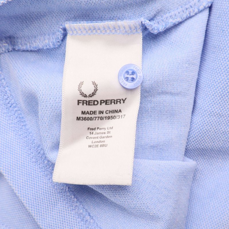 Tvättetikett med Fred Perry-märkning och tillverkningsland
