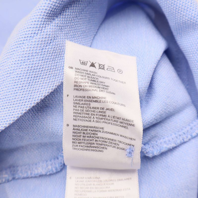 Materiallapp visar 100% bomull och tvättsymboler