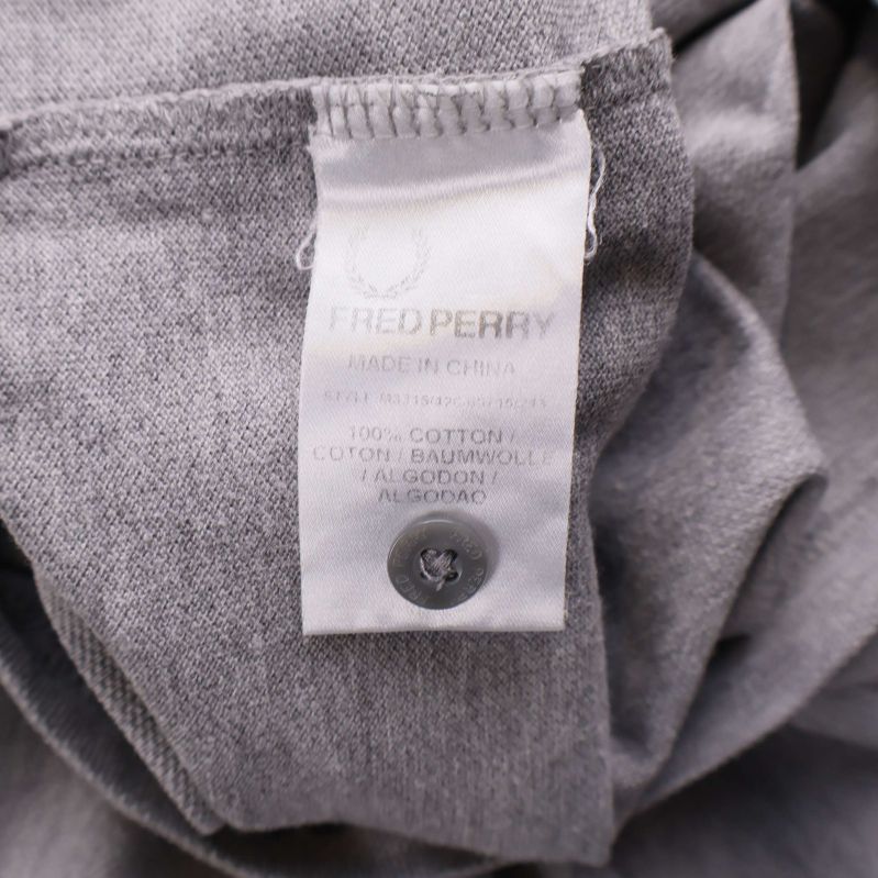 Tvättrådsetikett som visar 100% bomull och reservknapp