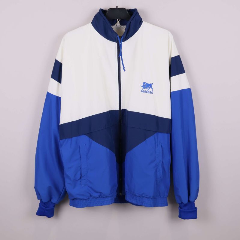 Jacka i blått och vitt med dragkedja och hög krage