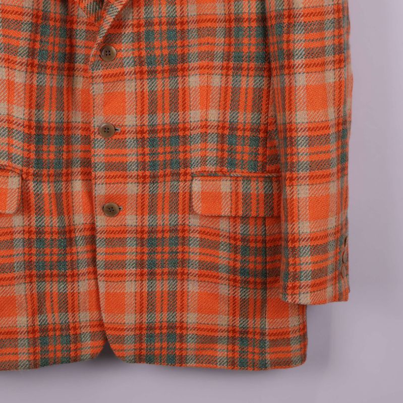 Nedre del av kavajen med fickor och knappdetaljer