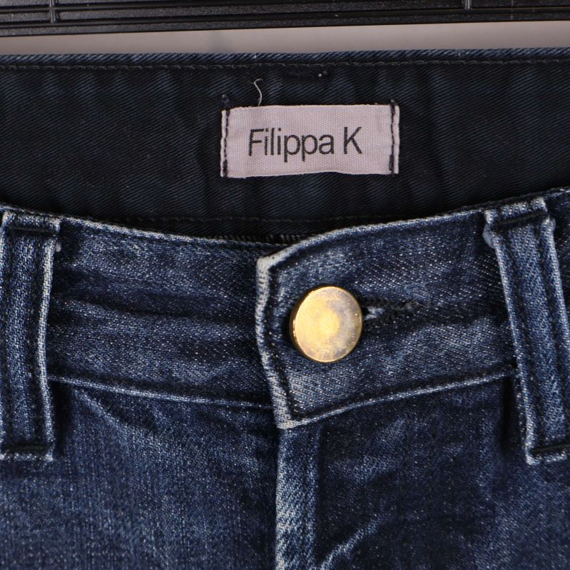 Närbild på linning och knapp med Filippa K-etikett