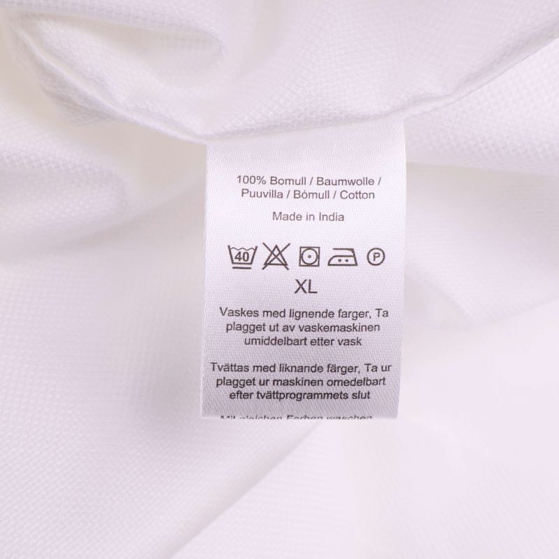 Materiallapp som visar 100% bomull och tvättråd