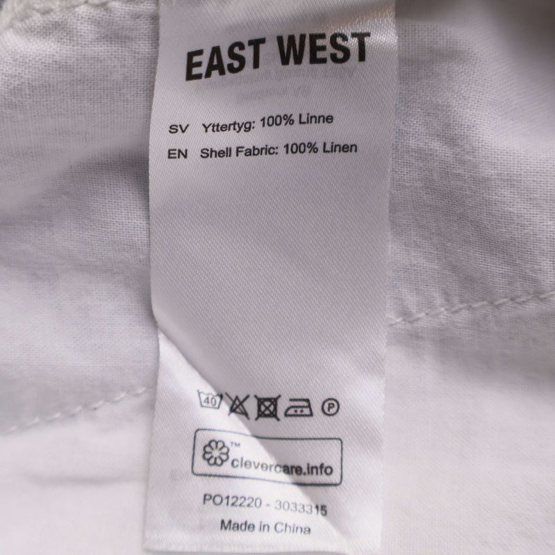 Materiallapp som visar 100% linne på shorts