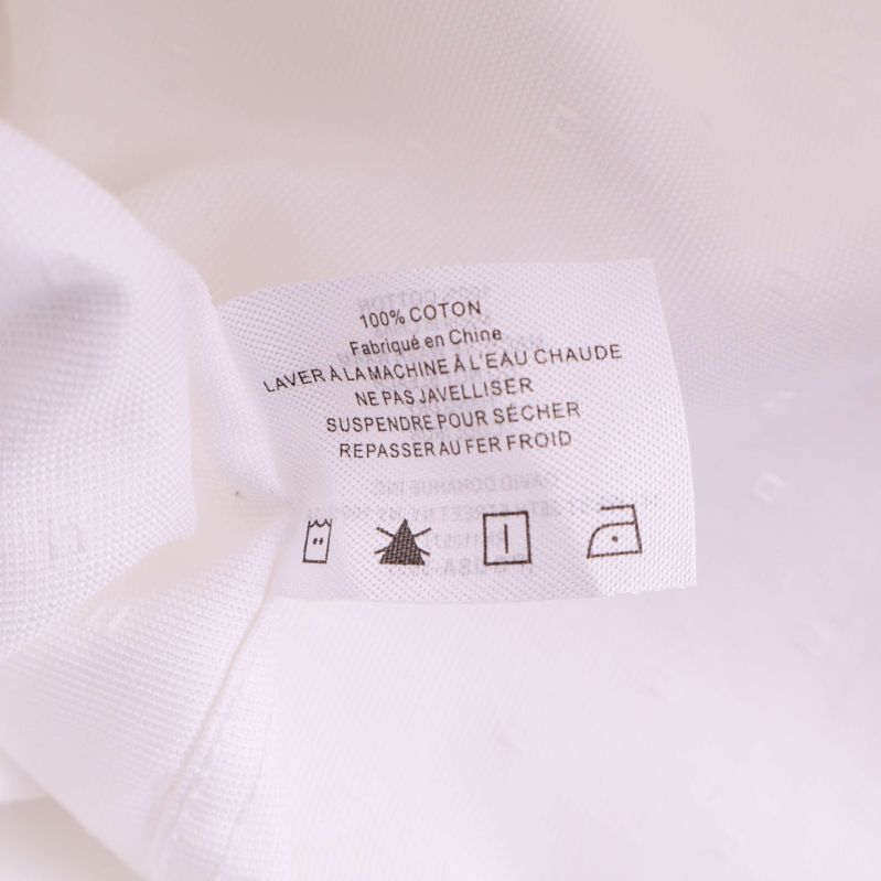 Materiallapp som visar 100 procent bomull