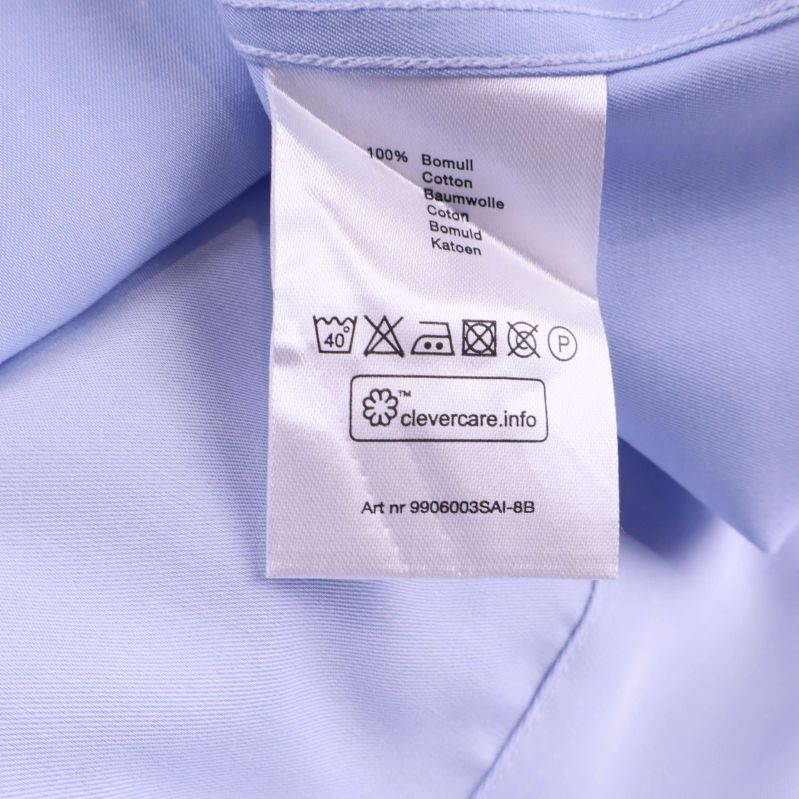 Materialetikett visar 100% bomull samt tvättråd