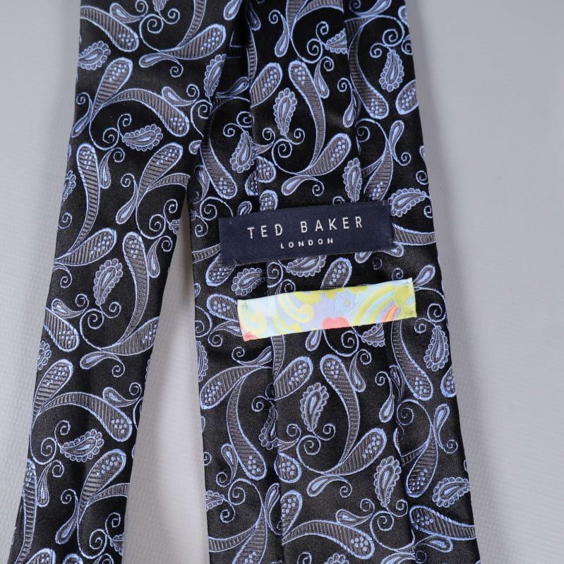 Närbild på Ted Baker-etikett och färgglatt band
