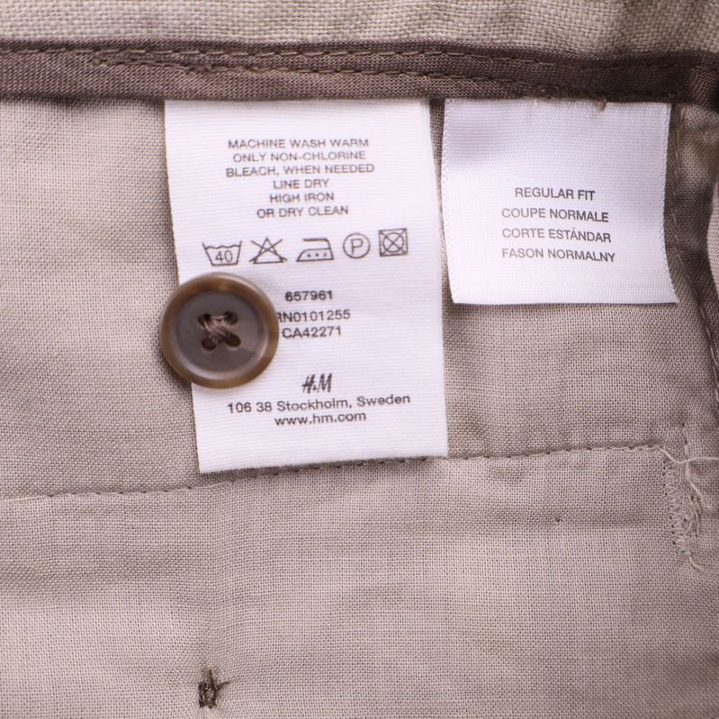 Tvättrådsetikett och knapp inuti byxorna