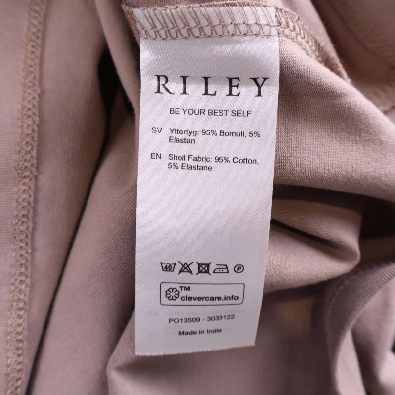 Materiallapp med fiberinnehåll för beige pikétröja