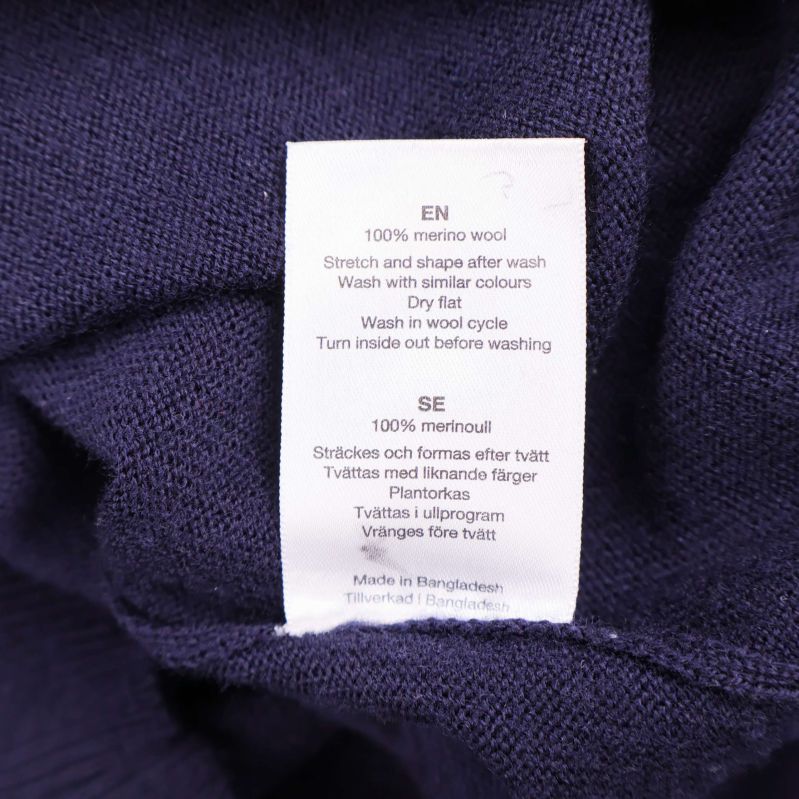 Textiletikett med materialinformation om 100% merinoull