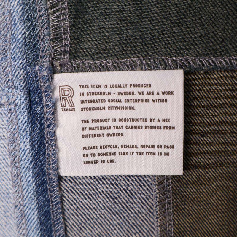 Textetikett om produktens ursprung och material