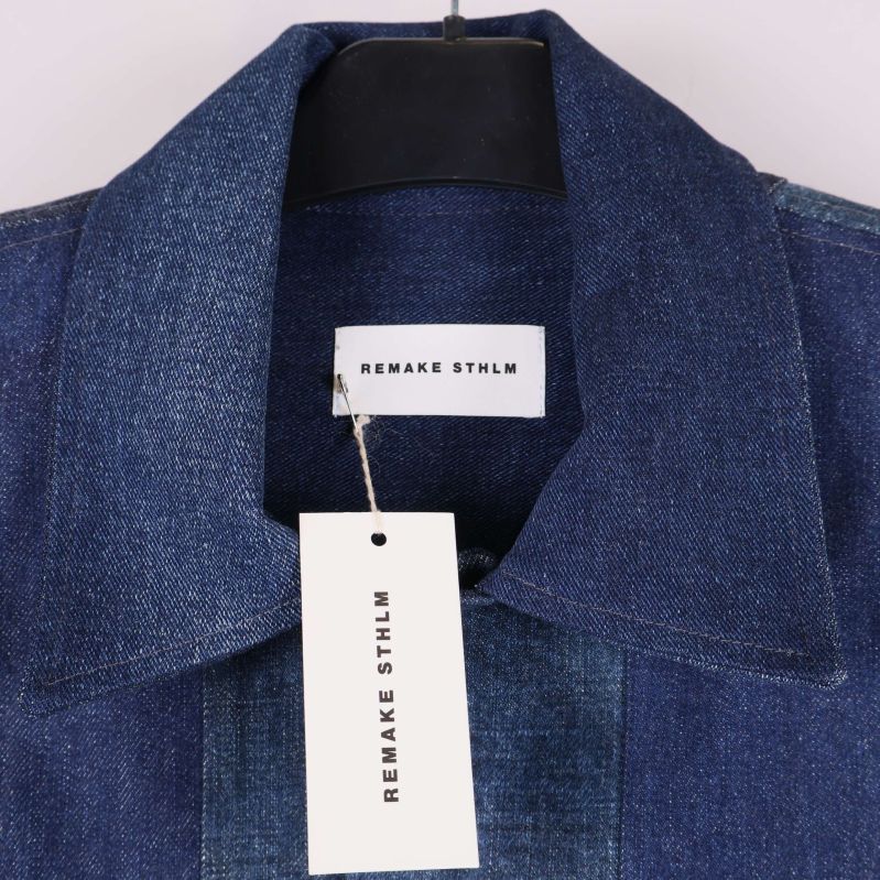 Närbild på jackans krage och Remake STHLM etikett