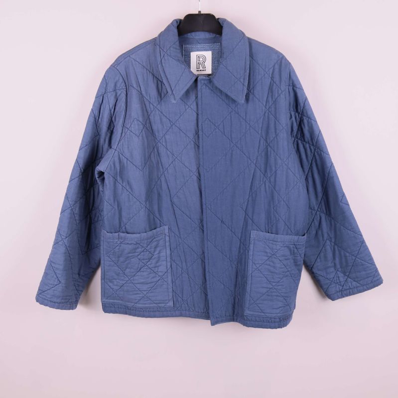 Helbild av blå quiltad jacka framifrån med fickor