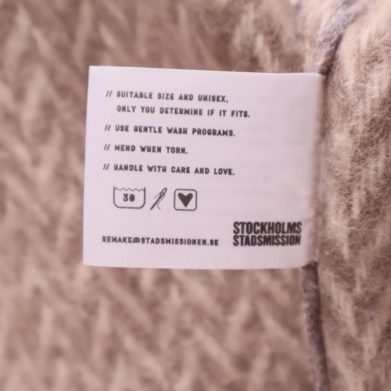 Tvättanvisningar och kontaktinfo på insida av jackan