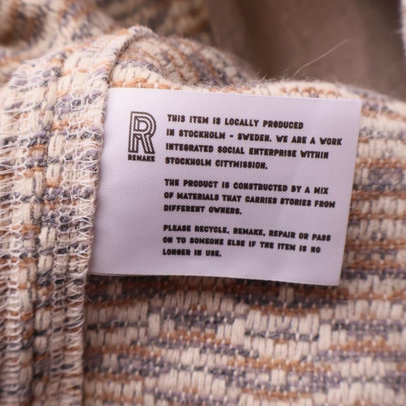 Tygmärke med information och remake-logotyp