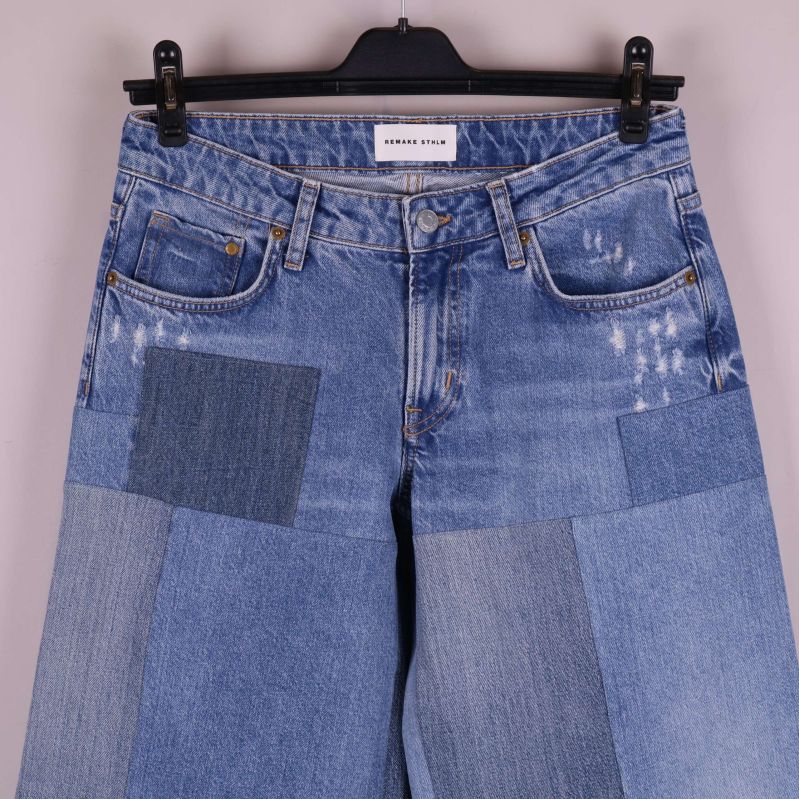 Patchwork jeans midja och fickor i närbild