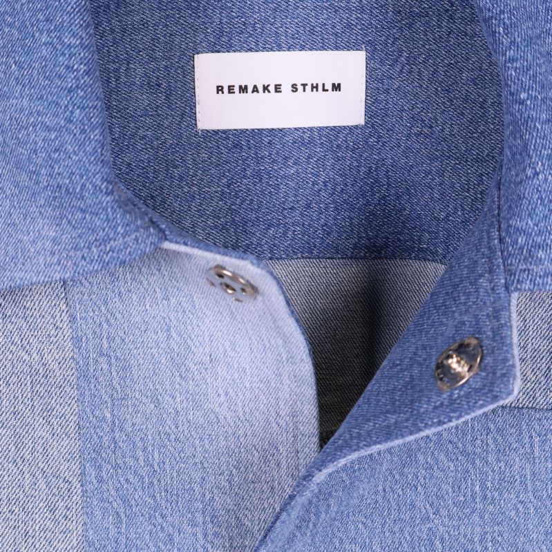 Närbild på krage och etikett Remake STHLM