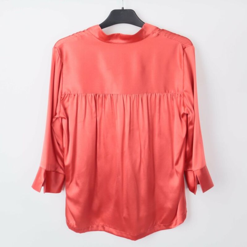 Baksidan av röd blus med veckad design