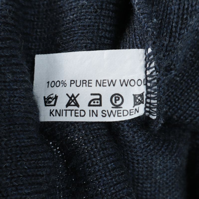 Materialetikett visar 100% ren ny ull