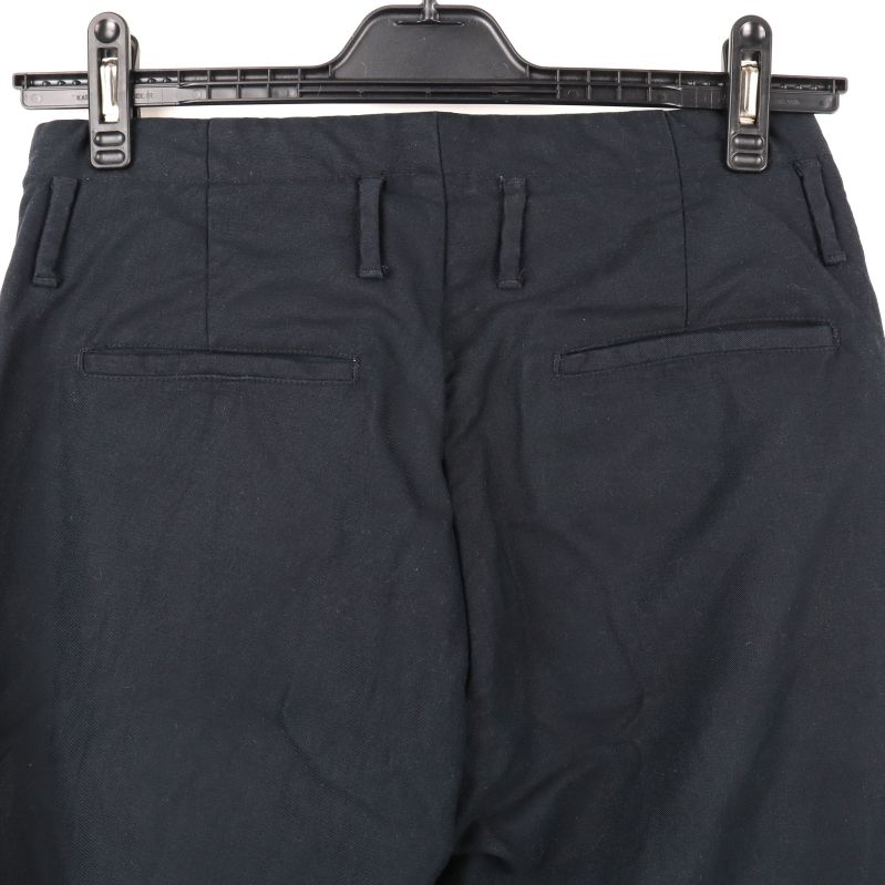 Detalj av bakfickorna på mörkblå chinos