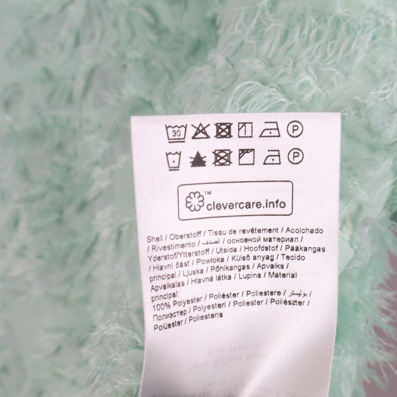 Materialetikett med specifikationer för mintgrön blus