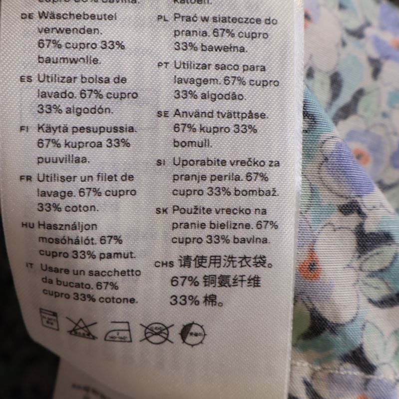 Materialetikett med 67% cupro och 33% bomull