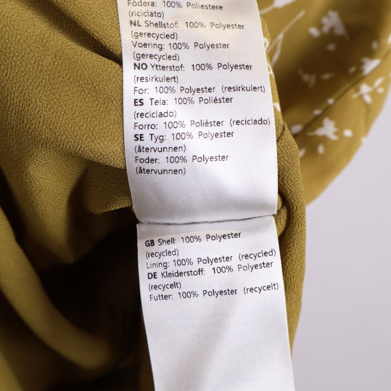 Materialetikett med polyesterinformation
