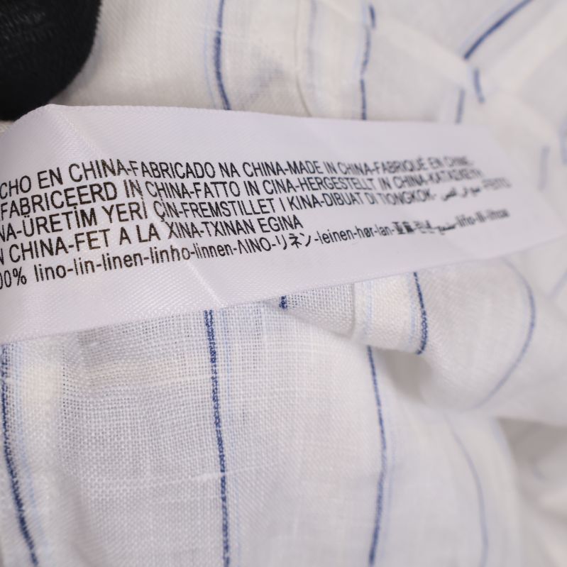 Materialetikett visar 100% linne