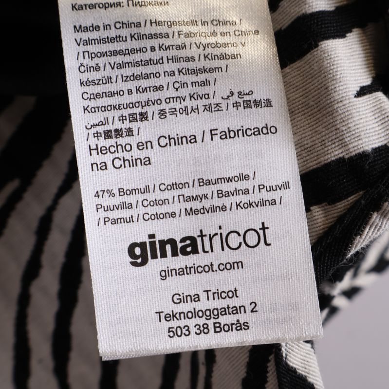 Etikett med materialinformation och Gina Tricot logga