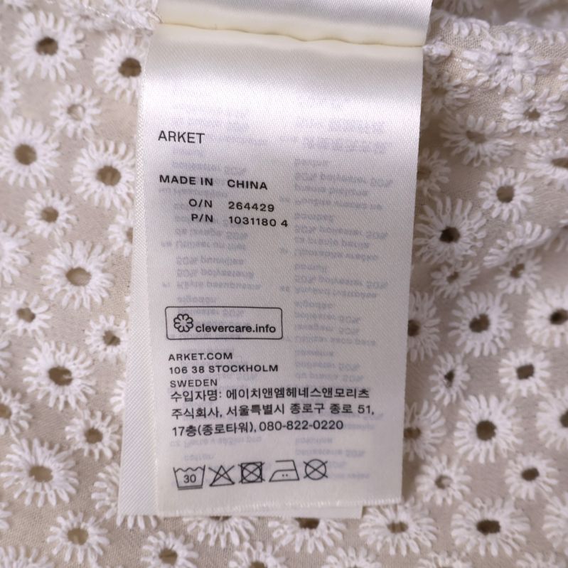 Tvättetikett med materialinformation för skjorta
