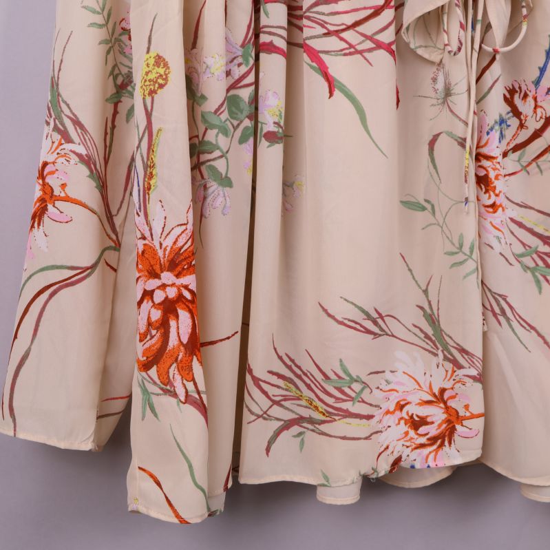 Närbild på blusens blommiga tyg